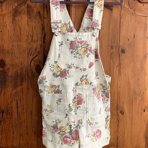 Adorable white overall shorts with flowers.